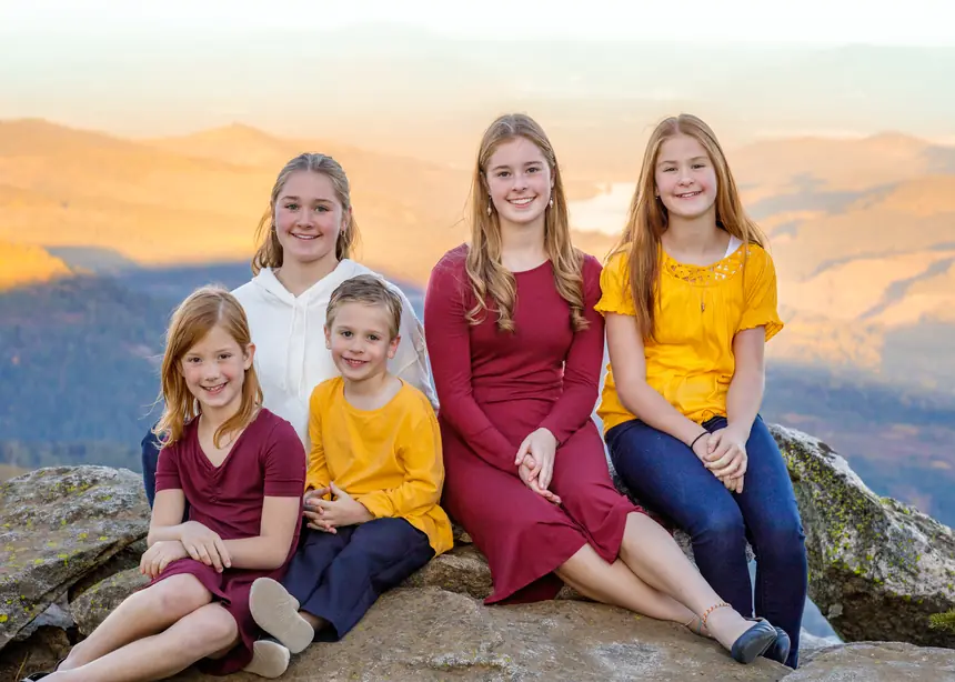 Kids smiling outdoors at sunset
